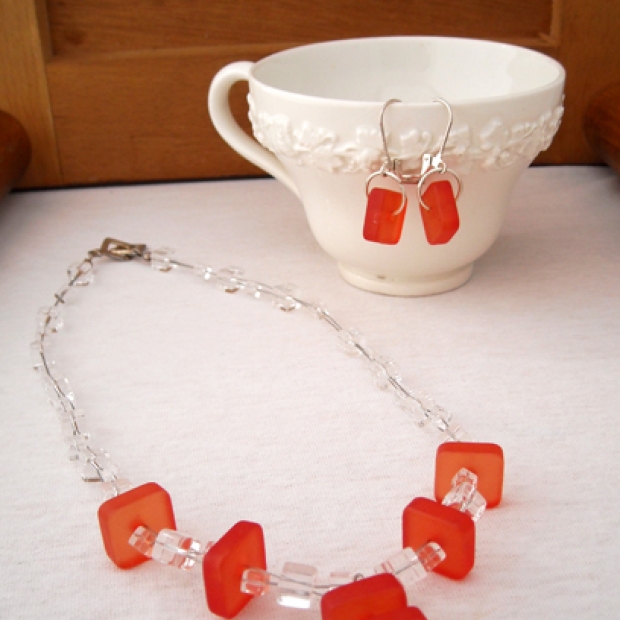 This is a necklace and earring set. I used clear glass beads and red frosted squares. $27